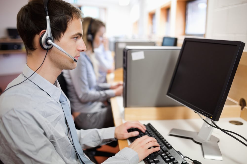 Serious operator using a computer in a call center